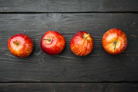 Ripe red apples set, on black wooden table background, top view flat lay, with copy space for textの写真素材