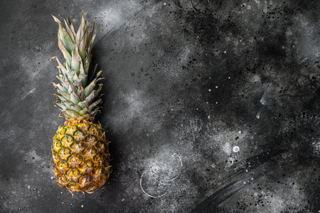 Pineapple tropical fruit set, on black dark stone table background, top view flat lay, with copy space for textの写真素材