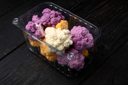 Ripe cauliflower set, in container, on black wooden table backgroundの写真素材