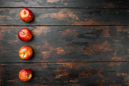Fresh red apple set, on old dark wooden table background, top view flat lay, with copy space for textの写真素材