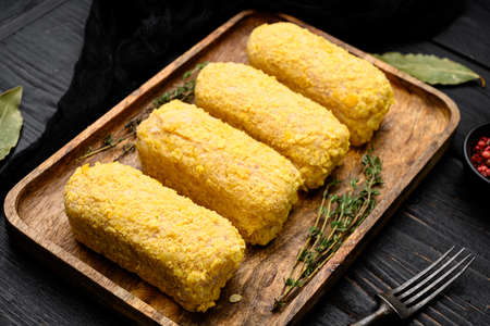 Breaded chicken patty set, on black wooden table backgroundの写真素材
