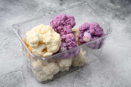 Organic colorful cauliflowers set, in container, on gray stone table backgroundの写真素材