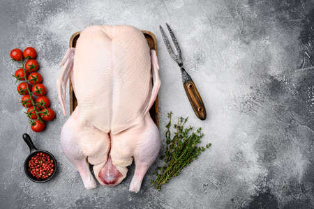 Gressingham duck ready to cook set with herbs, on gray stone table background, top view flat lay, with copy space for textの写真素材