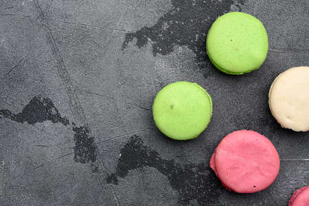 Sweet colorful macarons set, on gray stone table background, top view flat lay, with copy space for textの写真素材