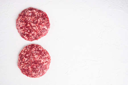 Patty of minced meat for burger set, on white stone background, top view flat lay, with copy space for textの写真素材