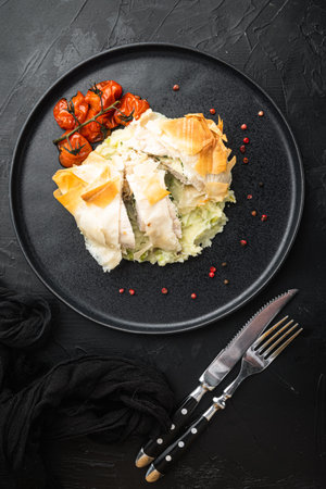 Freshly cooked Chicken Kiev oozing garlic and parsley butter set, with baked cherry tomatoes, mashed...