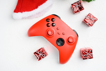 Christmas entertainment game pad set on white stone table background top view flat lay