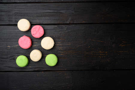 Colorful french macaroon set, on black wooden table background, top view flat lay, with copy space for textの写真素材