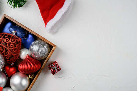 Christmas tree decoration set, in wooden box, top view flat lay, on white stone table background, with copy space for textの写真素材