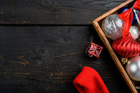 Vintage Christmas decorations set in wooden box, top view flat lay on black wooden table background, with copy space for textの写真素材