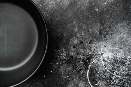 black pottery bowl set with copy space for text or food, with copy space for text or food, top view flat lay, on black dark stone table backgroundの写真素材