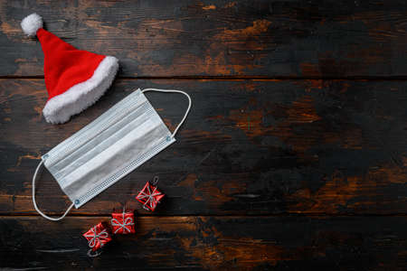 Year 2022 with Surgical Face Mask set on old dark wooden table background, top view flat lay with copy space for textの写真素材