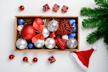Christmas decorations and objects, in wooden box , top view flat lay, on white stone table...