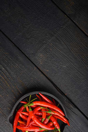 Ripe Cayenne pepper set, on black wooden table, top view flat lay, with copy space for textの写真素材