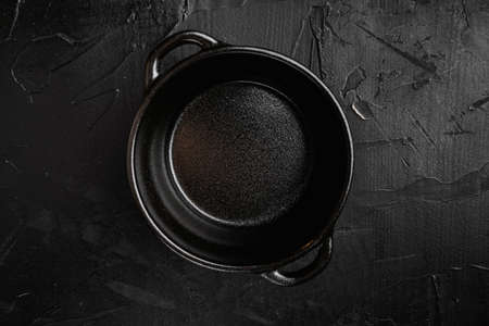 Empty serving food pot set with copy space for text or food with copy space for text or food, top view flat lay, on black dark stone table backgroundの写真素材