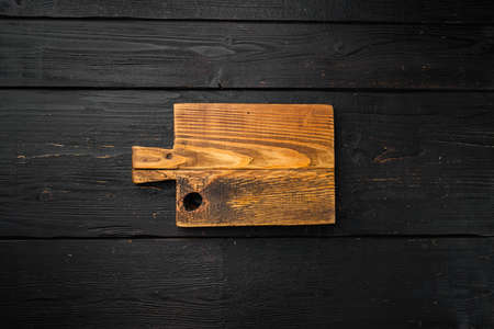 Rustic cutting board set, top view flat lay, with copy space for text or food, on black wooden table backgroundの写真素材