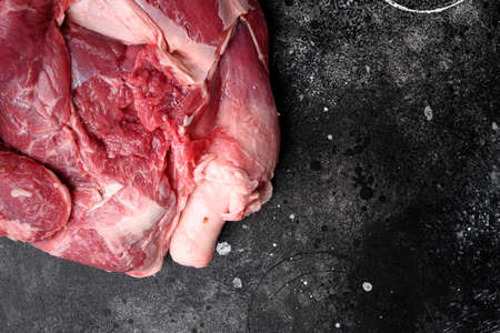 Raw meat products set, on black dark stone table background, top view flat lay, with copy space for textの写真素材
