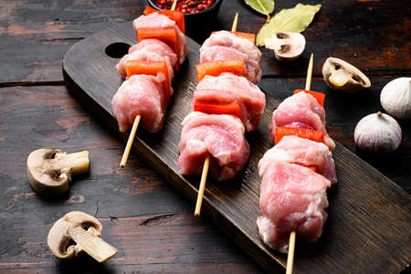 Shish kebab pork meat skewers or shashlik set, on old dark wooden table backgroundの写真素材