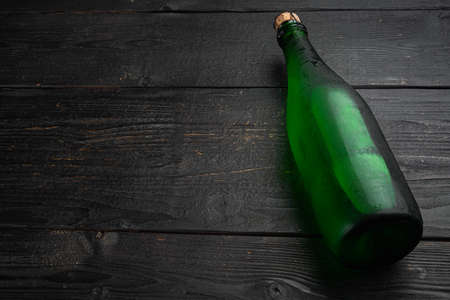 Glass bottle sparkling set, on black wooden table background, with copy space for textの写真素材