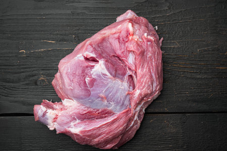 Raw meat, piece of pork set, on black wooden table background, top view flat lay, with copy space...