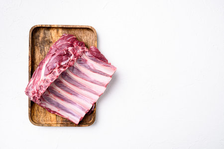 Organic Raw Lamb Chops set, on white stone table background, top view flat lay, with copy space for...