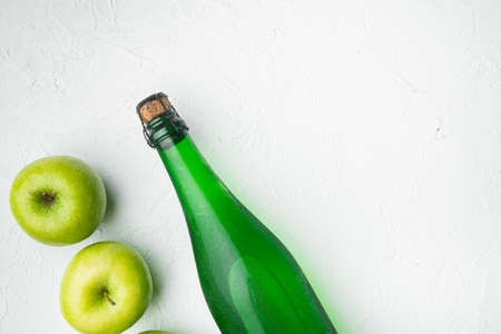 Fresh ripe apples and apple cider vinegar set, on white stone table background, top view flat lay, with copy space for textの写真素材