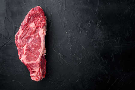 Freshly cut boneless ribeye big piece cut set, on black stone background, top view flat lay, with copy space for textの写真素材