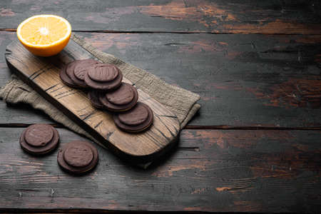 Orange Chocolate coated biscuit cakes set, on old dark wooden table background, with copy space for textの写真素材