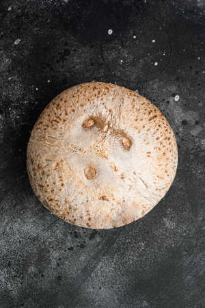 Whole ripe fresh Coconut set, on black dark stone table background, top view flat layの写真素材