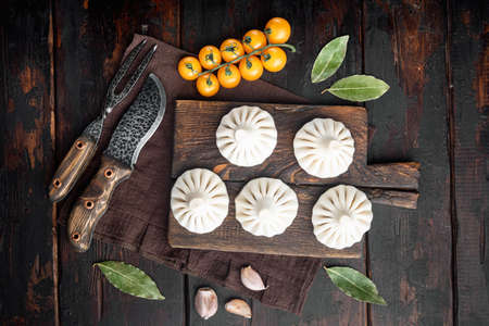 Khinkali, Georgian dumplings, traditional Georgian cuisine set, on old dark wooden table background, top view flat layの写真素材