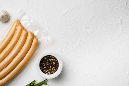 Vacuum chicken sausage pack set, on white stone table background, top view flat lay, with copy space for textの写真素材