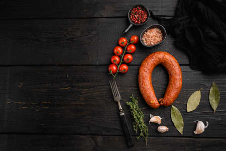 Cold smoked handmade sausage set, on black wooden table background, top view flat lay, with copy space for textの写真素材