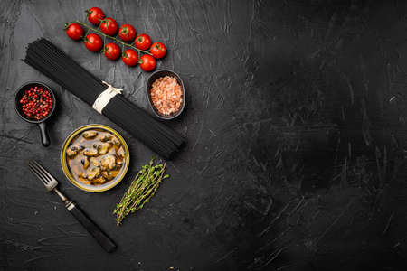 Raw ingredients Homemade Pasta Spaghetti with mussels set, on black dark stone table background, top view flat lay, with copy space for textの写真素材