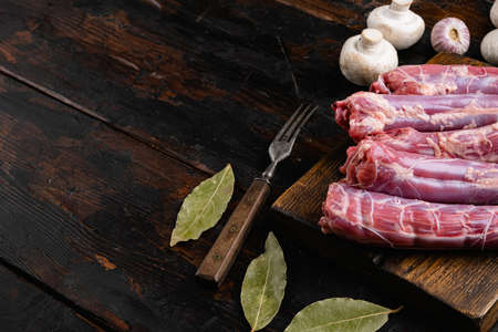 Raw duck neck set, on old dark wooden table background, top view flat lay, with copy space for textの写真素材