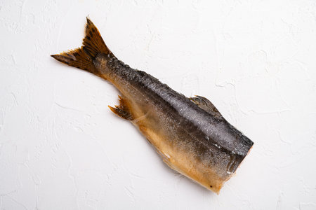 Whole hot smoked fish set, on white stone table background, top view flat lay, with copy space for...