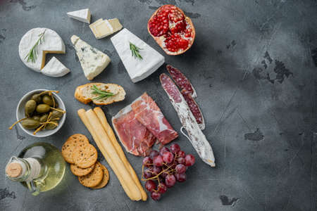 Appetizers table with differents antipasti set, on gray background, flat lay with copy space for textの写真素材