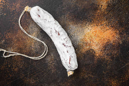 Salchichon salami sausage on dark background, flat lay with copy space.の写真素材