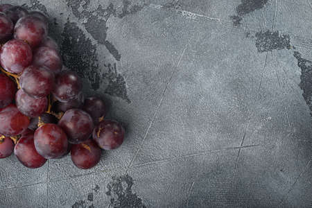 Ripe grape set, dark red fruits, on gray stone background, with copy space for textの写真素材