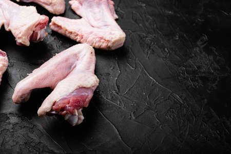 Fresh raw duck wings set, on black dark stone table background, with copy space for textの写真素材