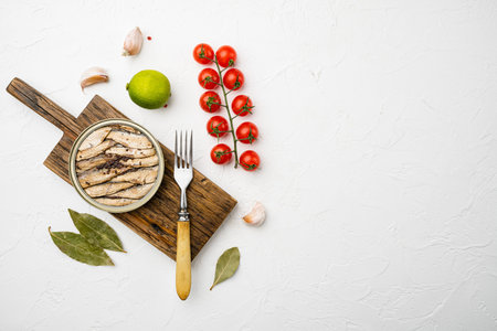 Smoked fish with olive oil set, on white stone table background, top view flat lay, with copy space...
