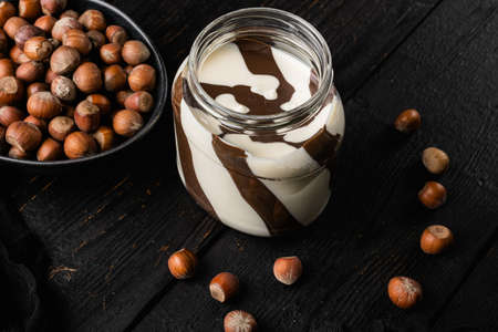 Chocolate Hazelnut Spread set, on black wooden table background, with copy space for textの写真素材