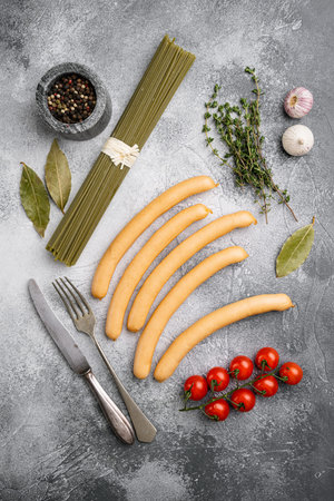 Classic boiled meat sausages set, on gray stone table background, top view flat lay
