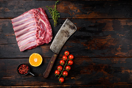 Lamb meat rib rack set, on old dark wooden table background, top view flat lay, with copy space for...