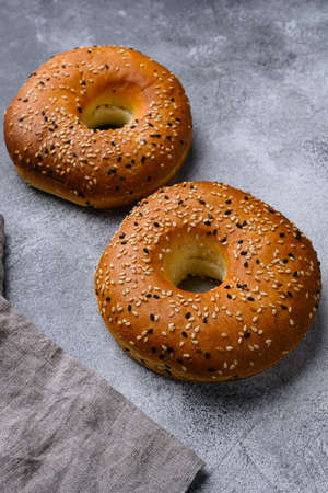 Fresh Bagels with Sesame, on gray stone table backgroundの写真素材