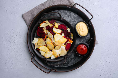 Root Vegetable Crisps set, on gray stone table background, top view flat lay, with copy space for textの写真素材