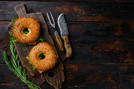 Bagel with red fish and soft cheese set, on old dark wooden table background, top view flat lay, with copy space for textの写真素材