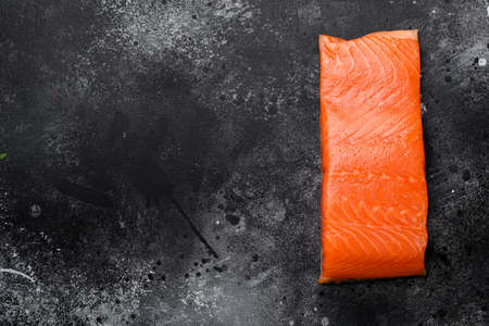 Raw Fillet of salmon set, on black dark stone table background, top view flat lay, with copy space for textの写真素材