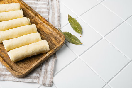 Frozen pancake stuffed, on white ceramic squared tile table background, with copy space for text