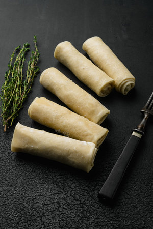 Frozen pancake stuffed, on black dark stone table background