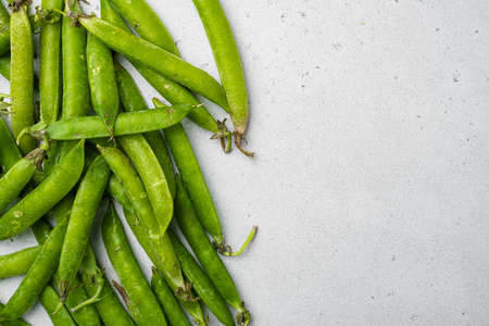 Green peas Freshly harvested , on gray stone table background, top view flat lay, with copy space for textの写真素材
